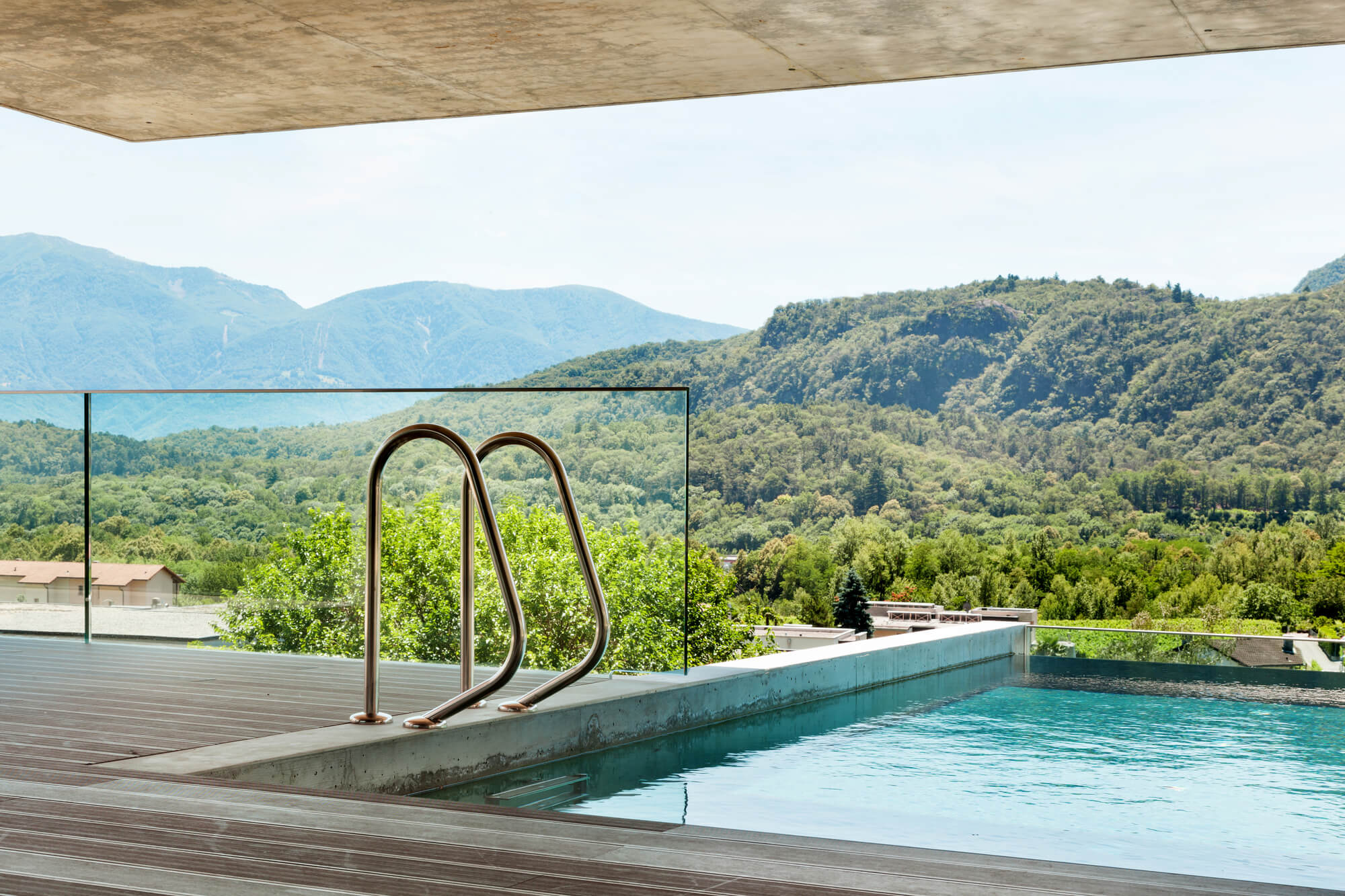 Inground pool with an open view by Big Easy Pool Designs
